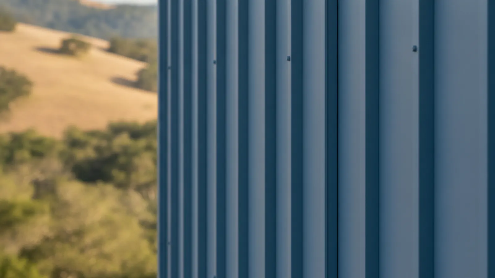 Close-up of vertical standing-seam metal wall panels with a matte factory finish